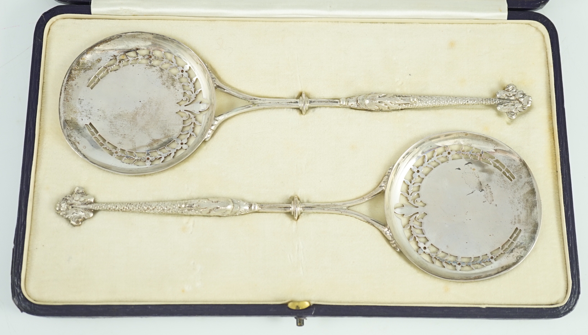 A pair of George V Asprey & Co pierced silver serving spoons